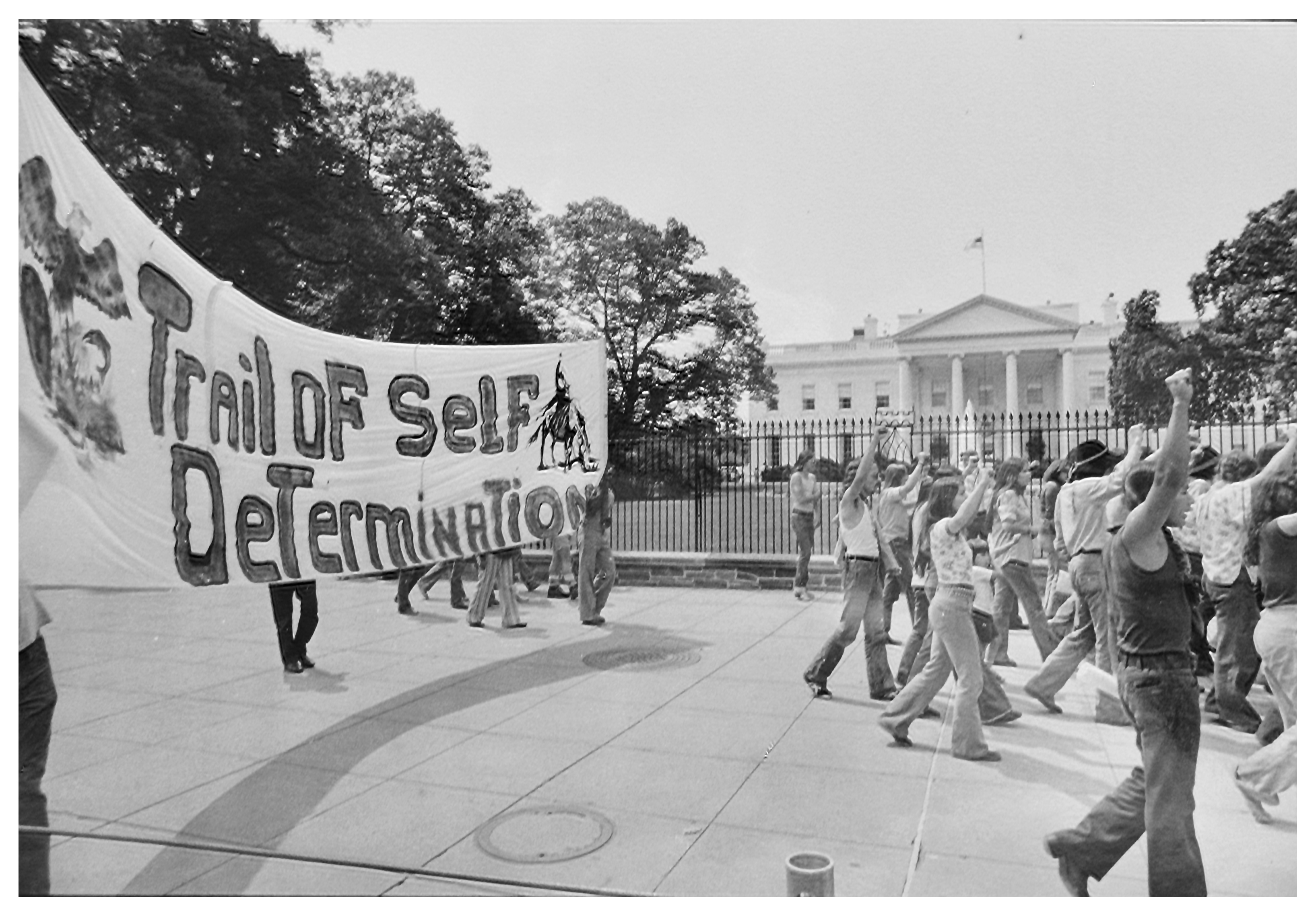 Black and white photograph showing AIM protserters marching during the Trail of Self Determination