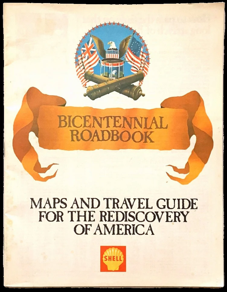 Color image of the cover of a roadbook published by Shell. The top features an image of an eagle atop a drum and two crossed cannons, with a 13 Colonies American flag to its right and a Union jack to its left.